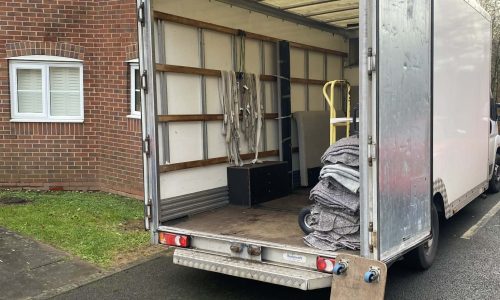 House removals team loading furniture into a van in Birmingham